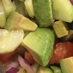 Avocado, tomato, cucumber, and onion salad with lemon-honey dressing